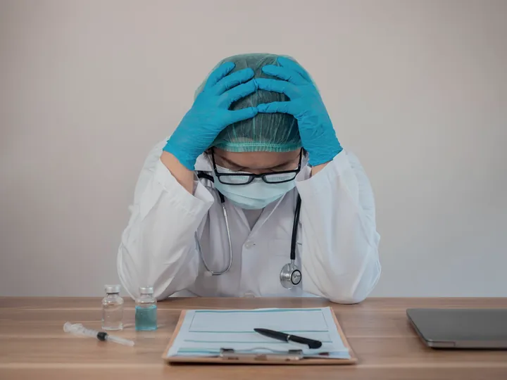 Exhausted doctor at a hospital desk