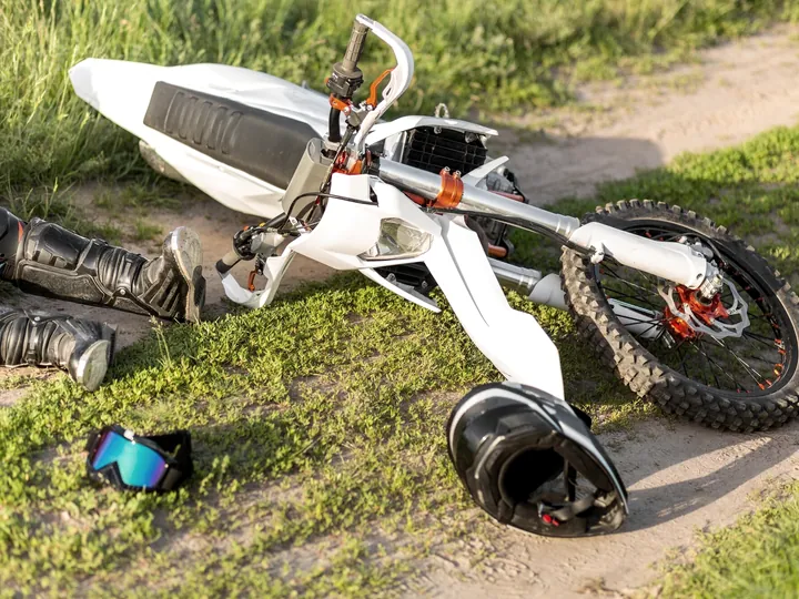Motorcycle and helmet on the ground after a crash